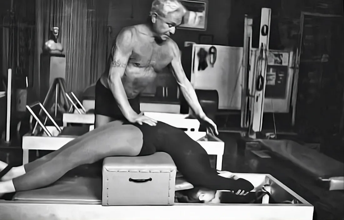 Vintage photograph of the Pilates method taught on the original apparatus