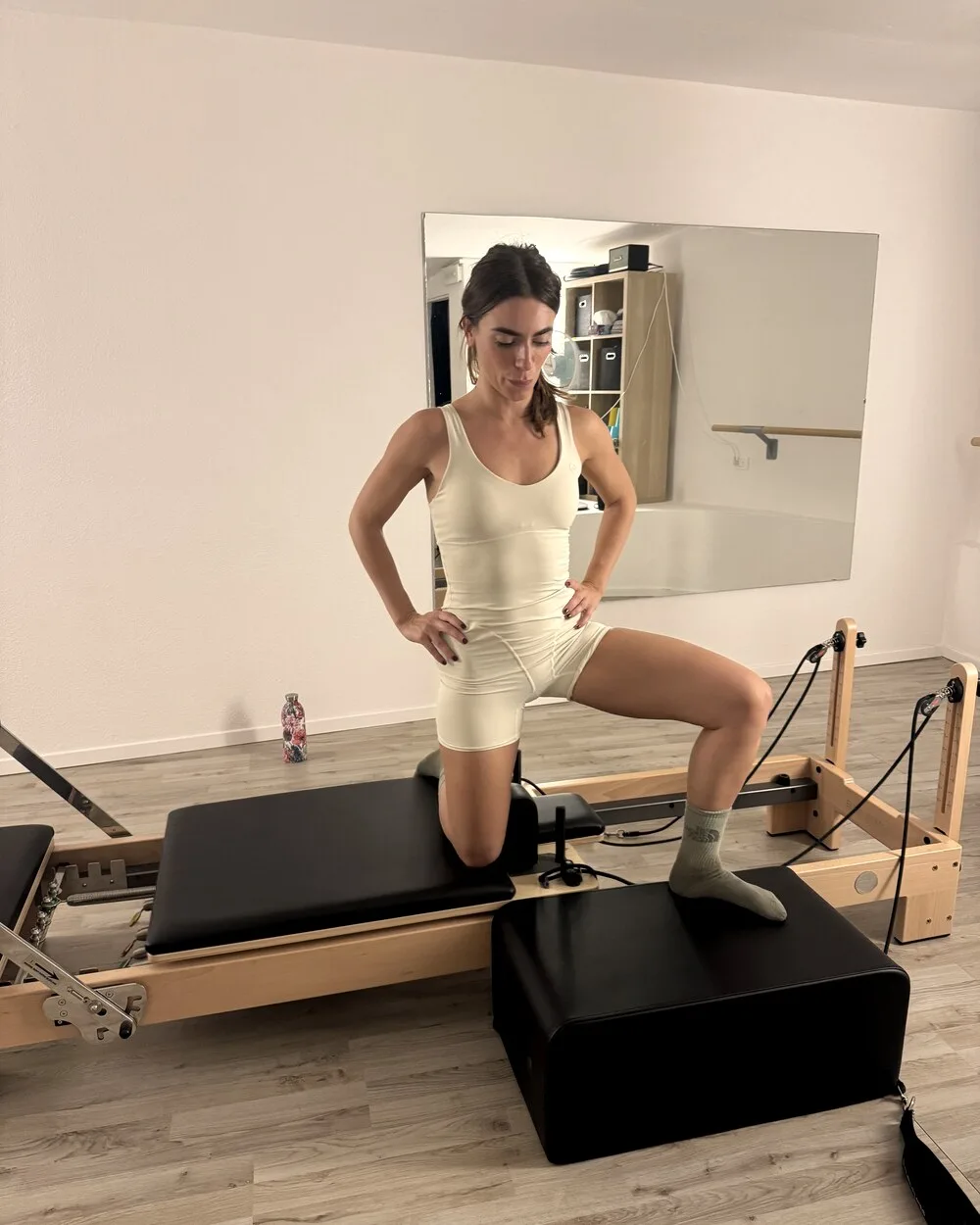 Client in a standing lunge on the reformer
